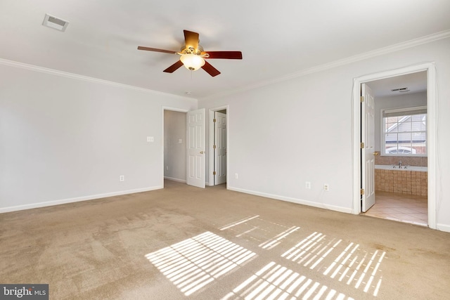 unfurnished bedroom with carpet floors, ornamental molding, visible vents, and baseboards