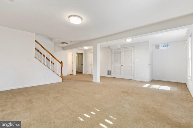 interior space with stairway, carpet, visible vents, and baseboards