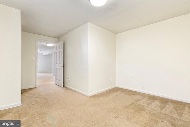 empty room with carpet floors and baseboards