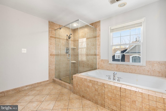 bathroom featuring visible vents, baseboards, a shower stall, a bath, and tile patterned floors