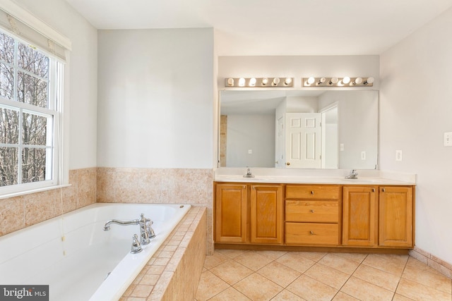 bathroom with a garden tub, double vanity, tile patterned flooring, and a healthy amount of sunlight