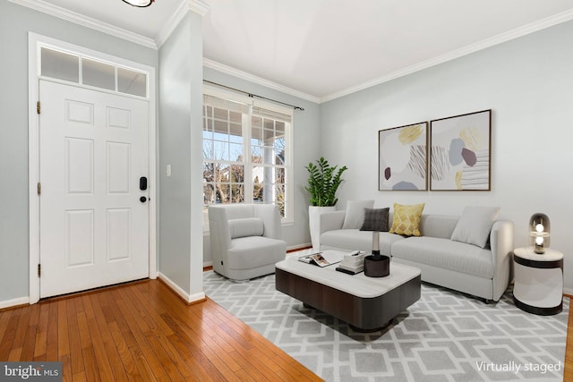 interior space featuring wood-type flooring, ornamental molding, and baseboards