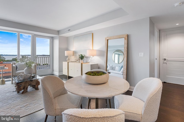 dining room featuring visible vents, baseboards, and dark wood-type flooring