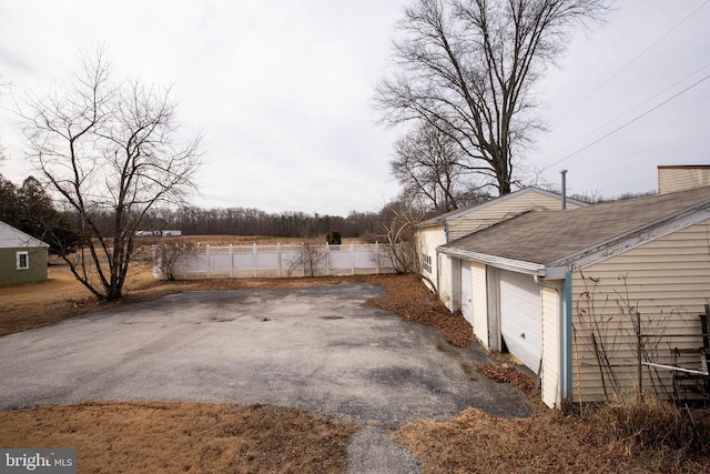 view of yard with a garage and fence