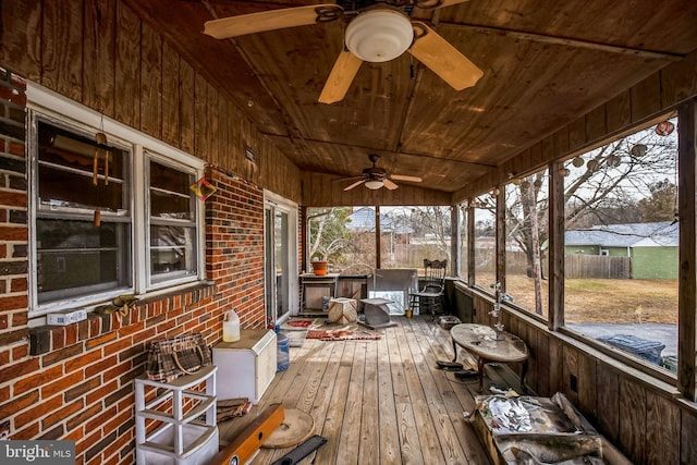 unfurnished sunroom with wooden ceiling and ceiling fan