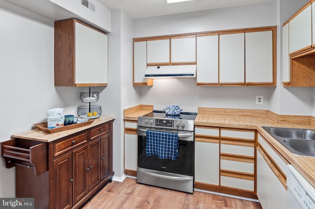 kitchen with white dishwasher, exhaust hood, visible vents, electric stove, and light countertops