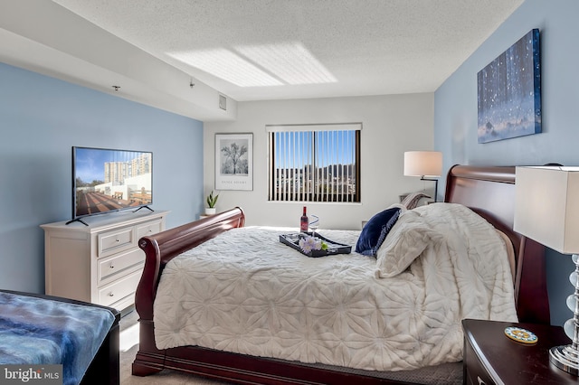 carpeted bedroom featuring a textured ceiling