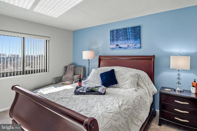 bedroom featuring a textured ceiling, baseboards, and carpet flooring