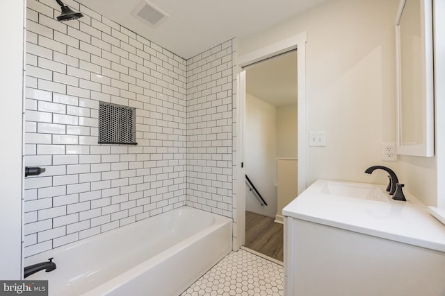 full bathroom with tile patterned flooring, washtub / shower combination, visible vents, and vanity