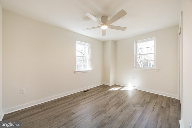 unfurnished room with ceiling fan, baseboards, and wood finished floors