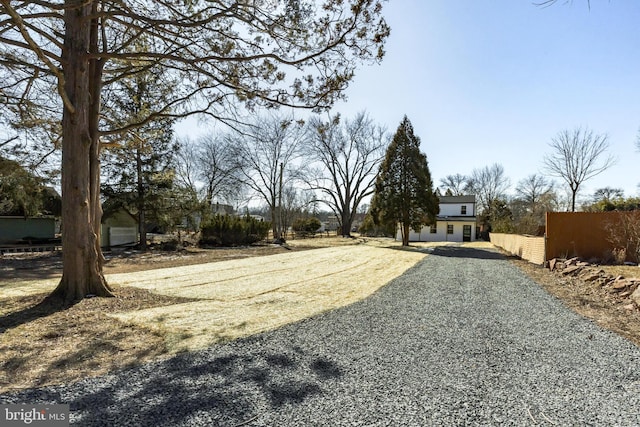 view of street featuring gravel driveway