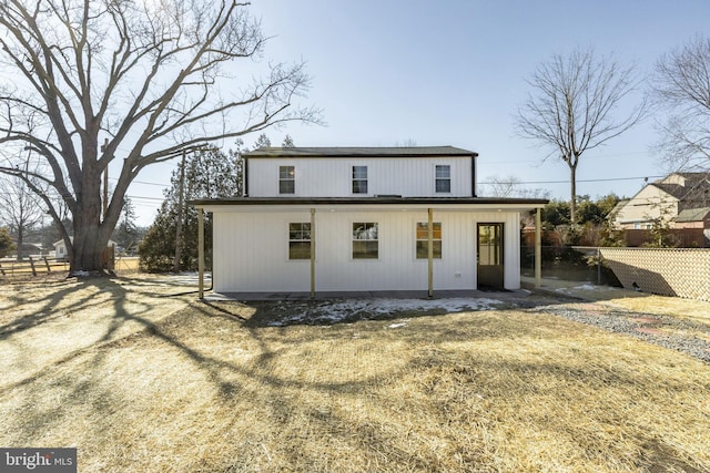 rear view of house with fence