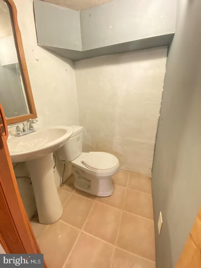 bathroom featuring toilet and tile patterned floors