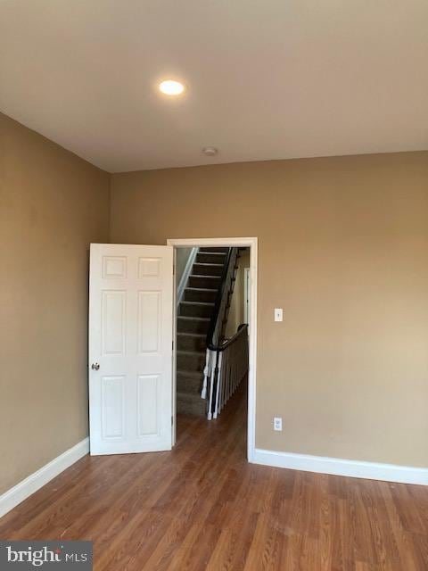 interior space featuring stairs, baseboards, and wood finished floors