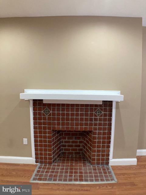 interior details featuring baseboards and wood finished floors