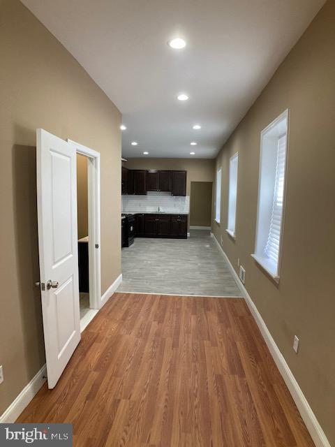 interior space featuring recessed lighting, light wood-type flooring, visible vents, and baseboards