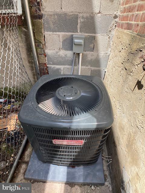 exterior details featuring fence and central AC unit