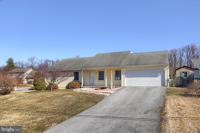 single story home featuring a shingled roof, fence, aphalt driveway, a front yard, and an attached garage