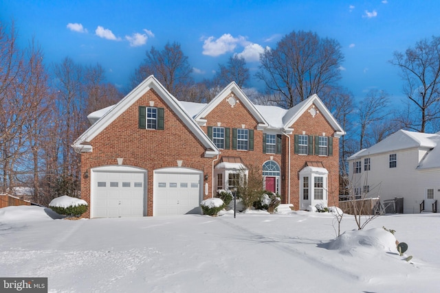 colonial-style house with a garage and brick siding