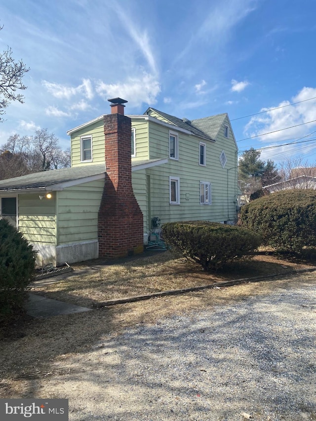 view of side of home with a chimney