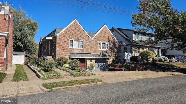 view of front of home with a garage, concrete driveway, and brick siding