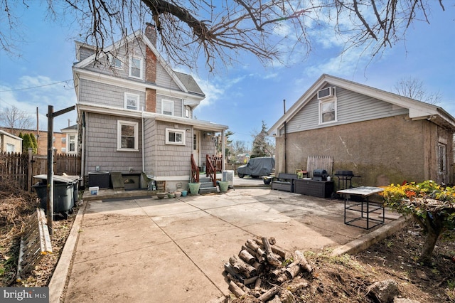 back of property with fence, central air condition unit, entry steps, a chimney, and a patio