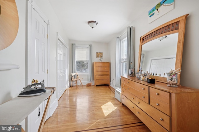 bedroom featuring baseboards and light wood finished floors