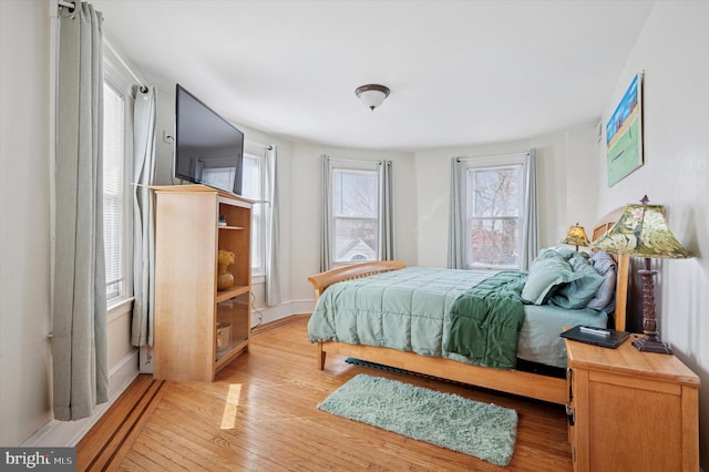 bedroom featuring baseboards and hardwood / wood-style floors