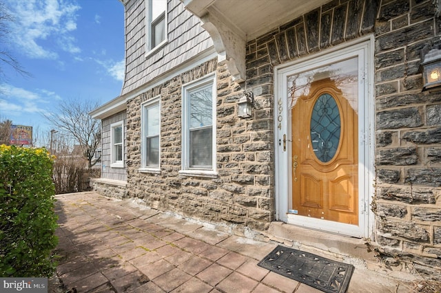 entrance to property featuring stone siding