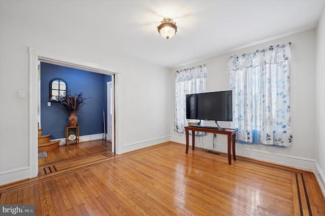 interior space featuring stairs, baseboards, and wood-type flooring