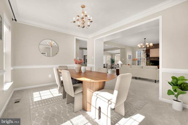 dining space featuring light colored carpet, visible vents, a notable chandelier, and baseboards