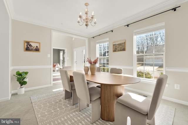 dining space featuring a chandelier, light colored carpet, visible vents, baseboards, and ornamental molding