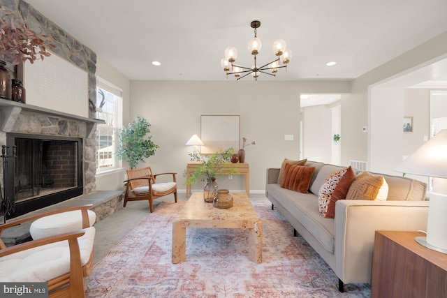 living area featuring visible vents, a fireplace, a chandelier, and recessed lighting