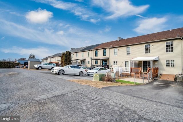 uncovered parking lot featuring a residential view