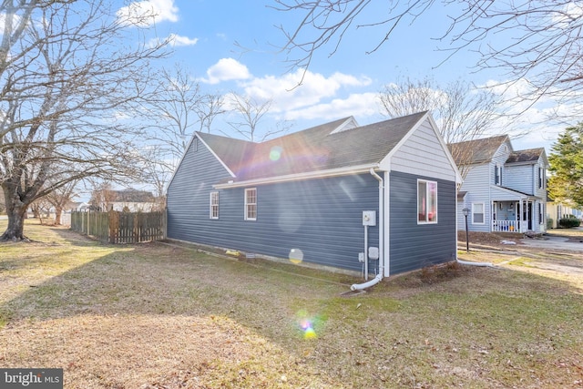 view of side of property featuring a yard and fence