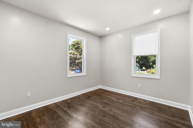 spare room featuring visible vents, baseboards, wood finished floors, and recessed lighting