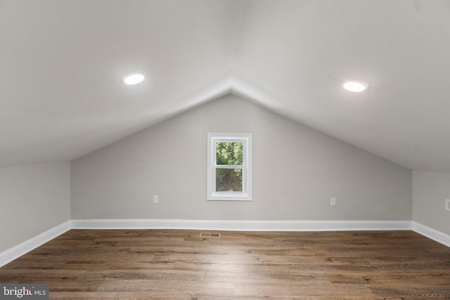 bonus room with baseboards, visible vents, dark wood finished floors, lofted ceiling, and recessed lighting