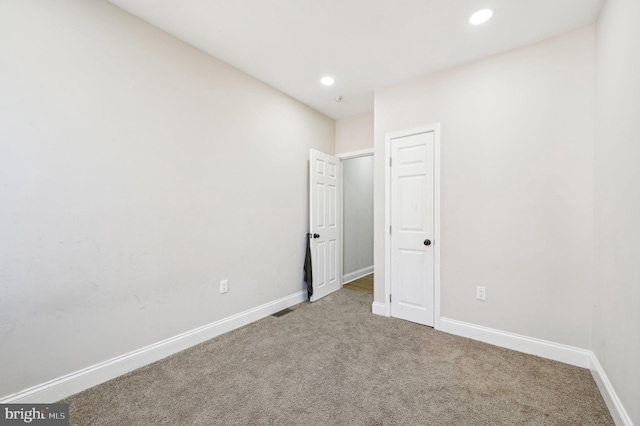 carpeted spare room with recessed lighting and baseboards