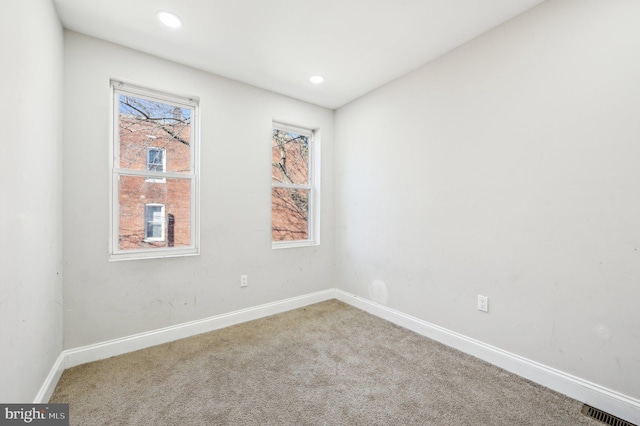 empty room with recessed lighting, baseboards, carpet floors, and visible vents