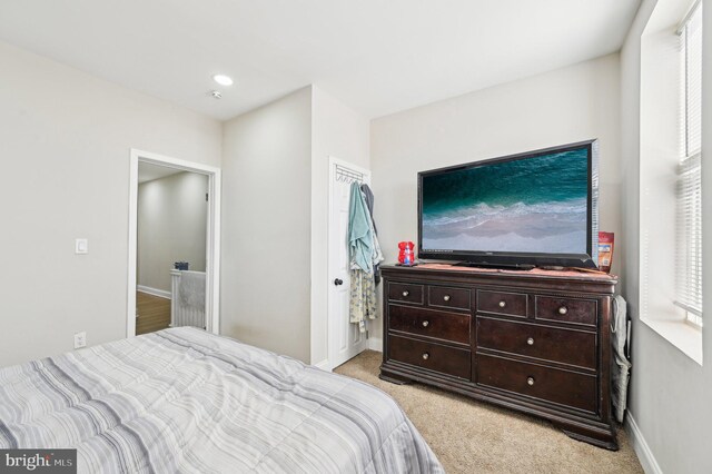 bedroom with recessed lighting, baseboards, and light carpet