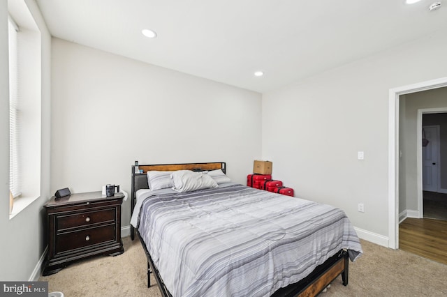 bedroom featuring light carpet, recessed lighting, and baseboards