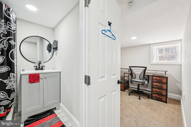 interior space with recessed lighting, vanity, and baseboards