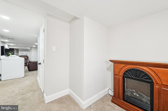 details featuring baseboards, carpet floors, recessed lighting, washer / dryer, and a fireplace