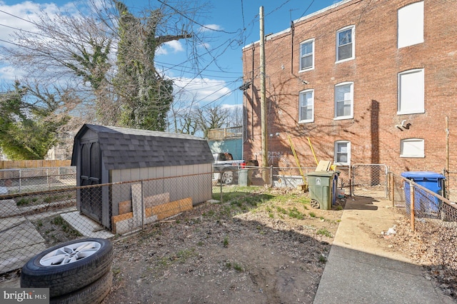 view of yard with an outbuilding, a storage unit, and a fenced backyard