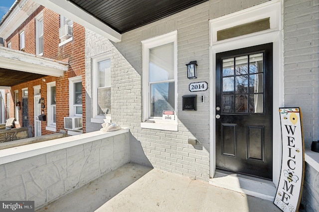 property entrance with brick siding