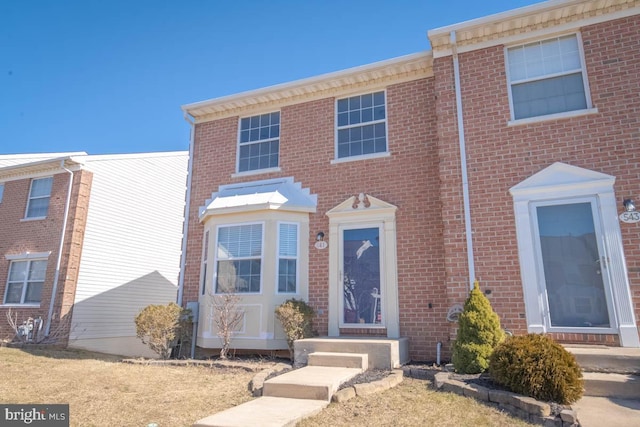 townhome / multi-family property featuring brick siding