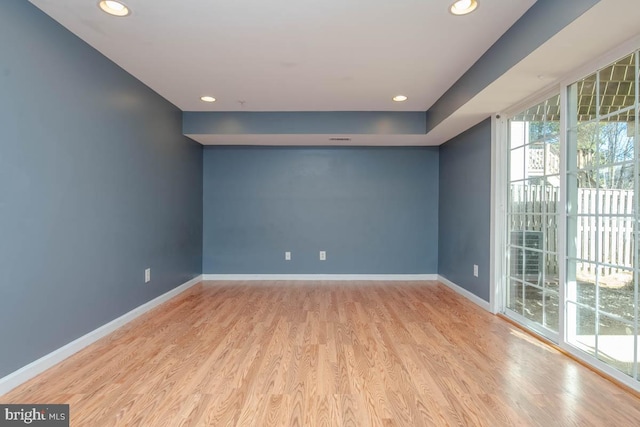 unfurnished room with recessed lighting, baseboards, and wood finished floors