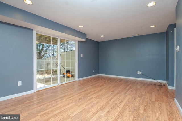 empty room with recessed lighting, baseboards, and wood finished floors