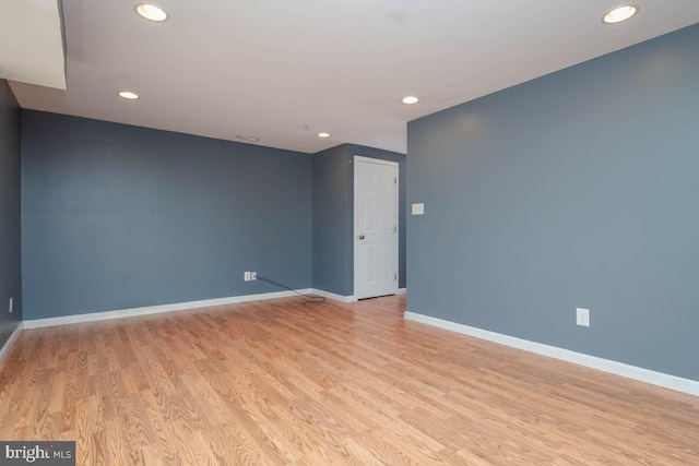 spare room with light wood-type flooring, baseboards, and recessed lighting