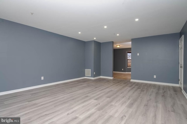 unfurnished living room featuring recessed lighting, visible vents, light wood finished floors, and baseboards